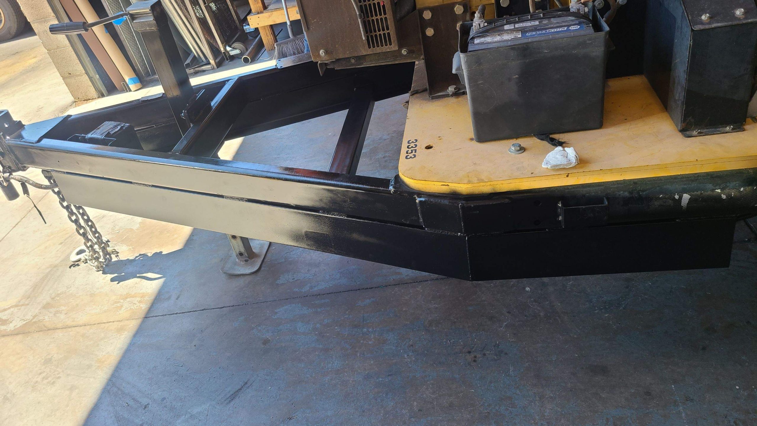 Close-up of a black metal frame with angled beams and cross braces.